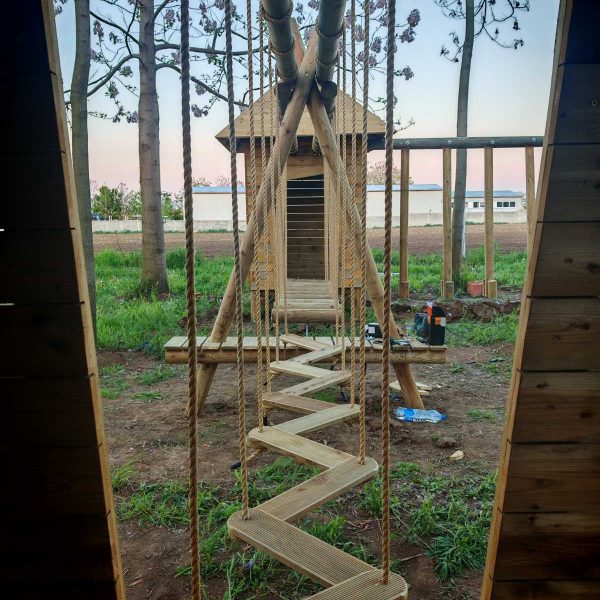 Wooden Running Rhino playground featuring a snake bridge